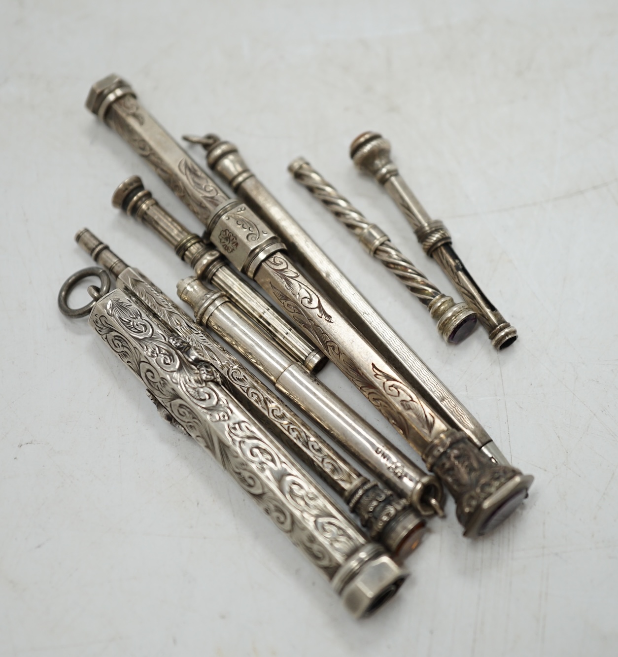 Two sterling cased propelling pencils and six other white metal cased propelling pencils, largest 91mm. Condition - fair
